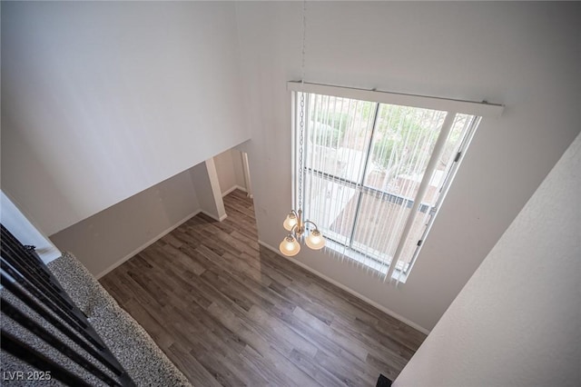 interior space featuring baseboards and wood finished floors