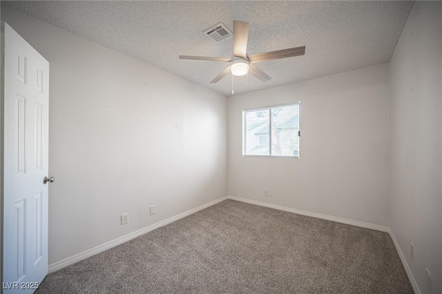 carpeted empty room with a ceiling fan, visible vents, a textured ceiling, and baseboards