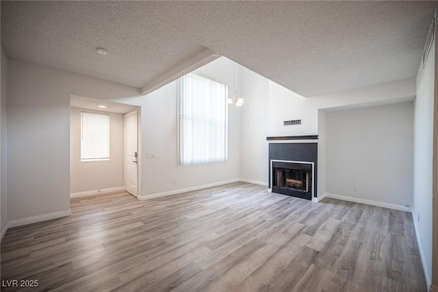 unfurnished living room featuring light wood finished floors, a fireplace, and baseboards