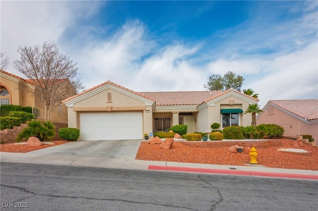 view of front of house with concrete driveway, an attached garage, a tile roof, and stucco siding