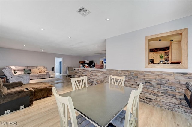 dining room with wood finished floors, visible vents, and recessed lighting