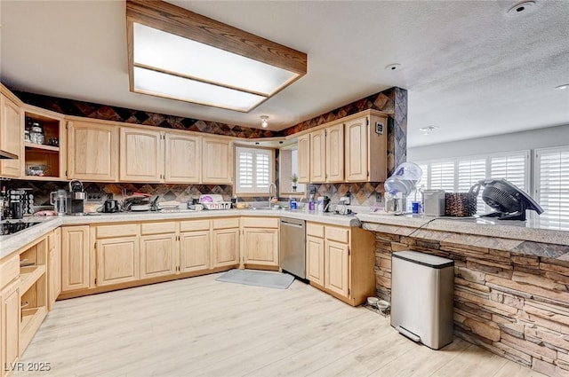 kitchen with light countertops, dishwasher, light wood finished floors, and light brown cabinetry