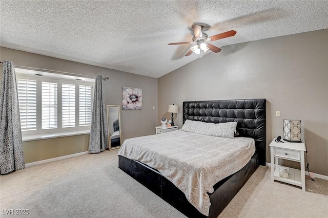 bedroom featuring a textured ceiling, a ceiling fan, baseboards, vaulted ceiling, and carpet