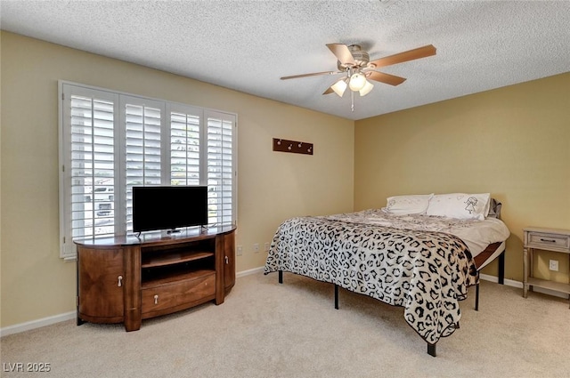 bedroom with carpet flooring, a textured ceiling, and baseboards