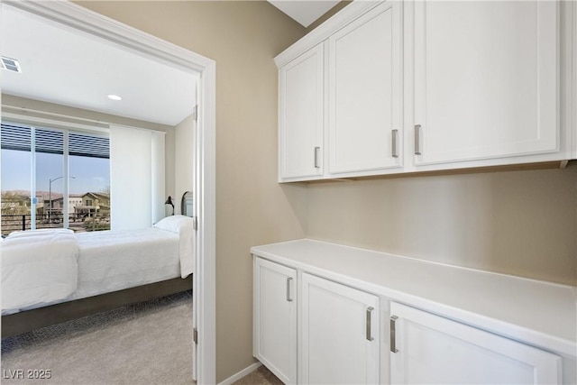 bedroom with light carpet and visible vents