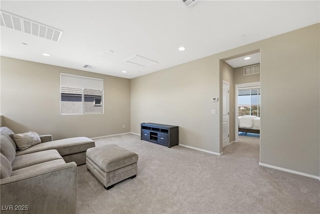 carpeted living area featuring baseboards, visible vents, and recessed lighting