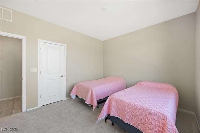 bedroom featuring carpet, visible vents, and baseboards