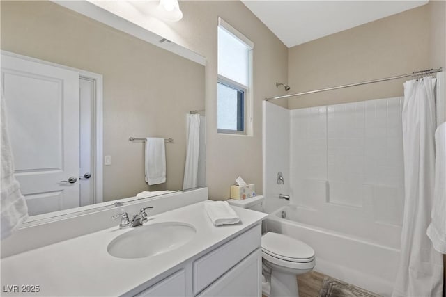 full bathroom featuring toilet, shower / bath combo with shower curtain, and vanity