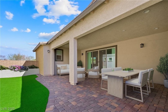 view of patio / terrace with outdoor dining area, outdoor lounge area, and fence