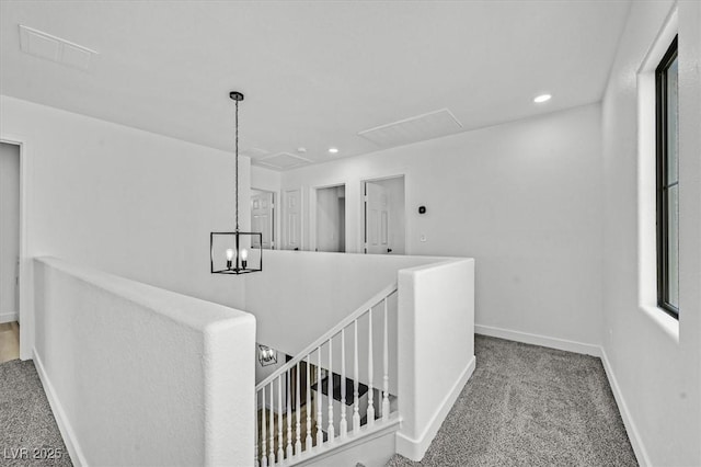 hall with recessed lighting, baseboards, carpet flooring, and an upstairs landing