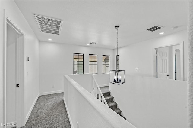 hall with carpet floors, recessed lighting, and visible vents