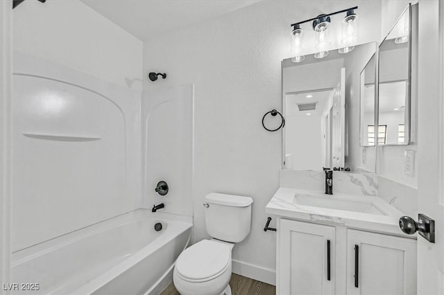 bathroom featuring visible vents, shower / bathing tub combination, toilet, vanity, and baseboards