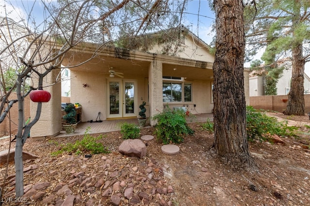 back of house featuring a ceiling fan, fence, french doors, a patio area, and stucco siding