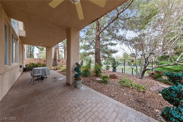 view of patio with a fenced backyard and a ceiling fan