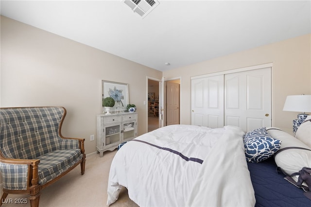 bedroom with light carpet, a closet, visible vents, and baseboards