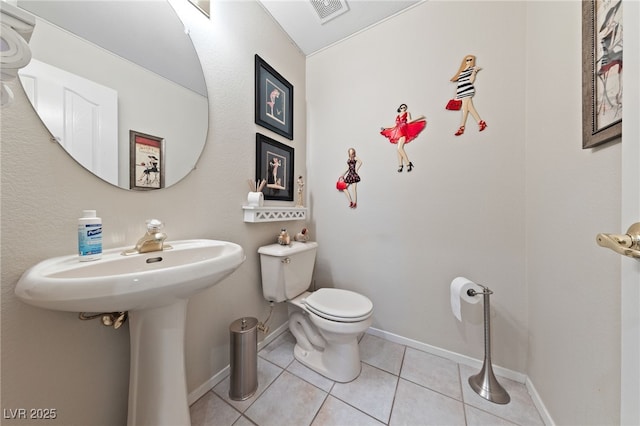 half bathroom featuring tile patterned flooring, baseboards, visible vents, and toilet