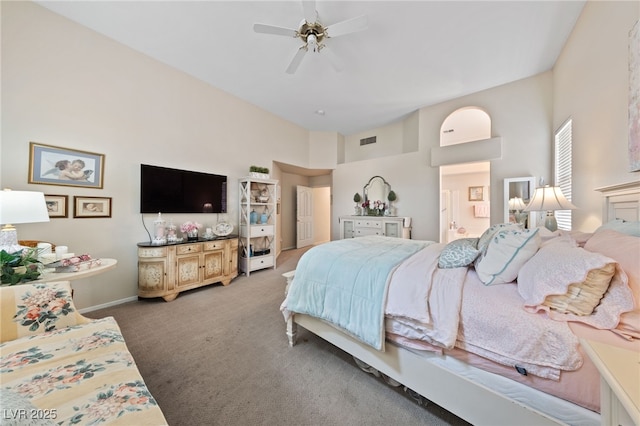 bedroom featuring carpet, visible vents, connected bathroom, ceiling fan, and baseboards