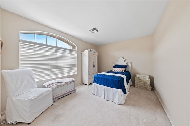 carpeted bedroom with visible vents and baseboards