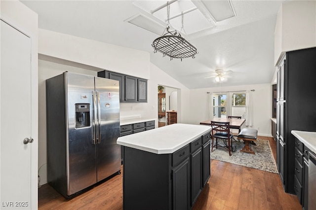 kitchen featuring light countertops, wood finished floors, and stainless steel fridge