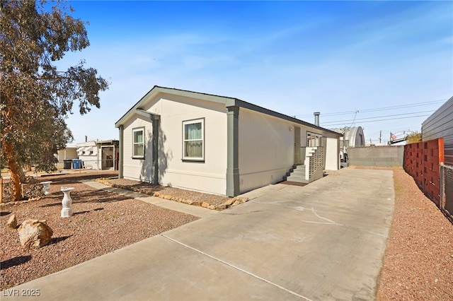 view of side of property featuring fence