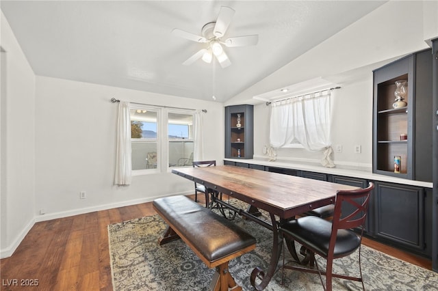 dining room with lofted ceiling, dark wood finished floors, baseboards, and ceiling fan