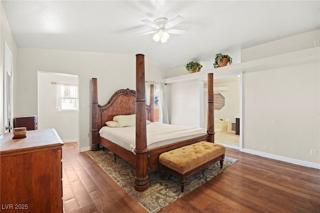 bedroom with a ceiling fan, connected bathroom, baseboards, and wood finished floors