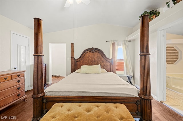 bedroom featuring a ceiling fan, vaulted ceiling, decorative columns, and wood finished floors