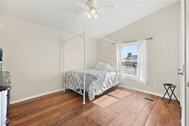 bedroom with vaulted ceiling, wood finished floors, a ceiling fan, and baseboards