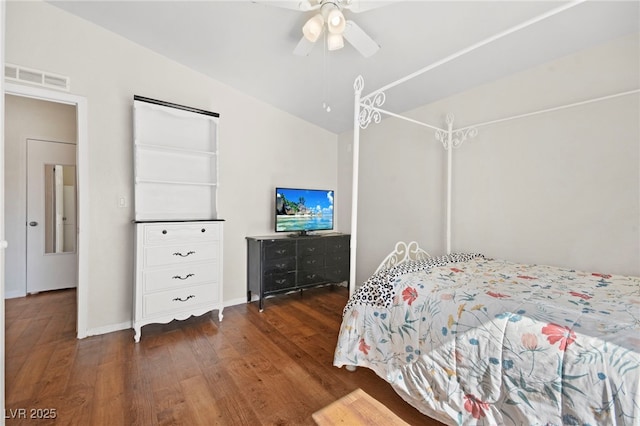 bedroom with baseboards, visible vents, a ceiling fan, lofted ceiling, and wood finished floors