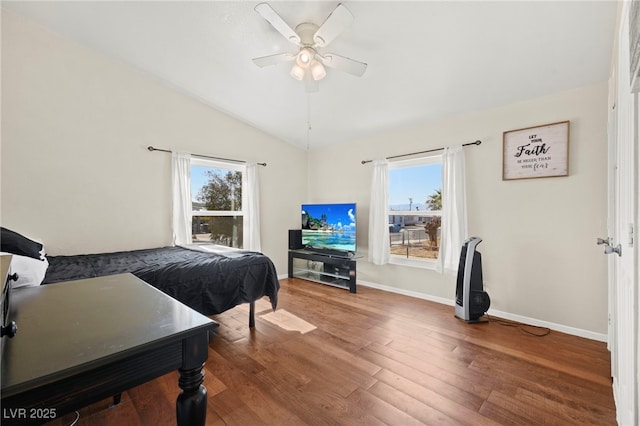 bedroom with lofted ceiling, ceiling fan, baseboards, and wood finished floors