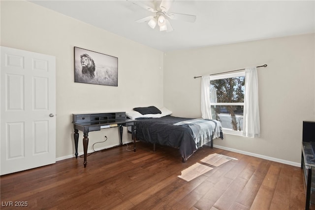 bedroom with ceiling fan, baseboards, and wood finished floors