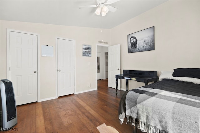 bedroom with visible vents, a ceiling fan, vaulted ceiling, wood finished floors, and baseboards