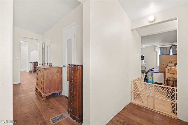 hallway with visible vents and wood finished floors