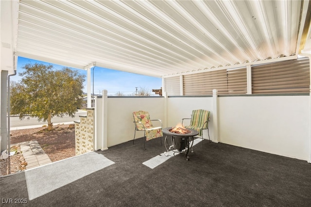 view of patio with a fire pit and fence