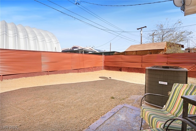 view of yard featuring a fenced backyard and central AC unit