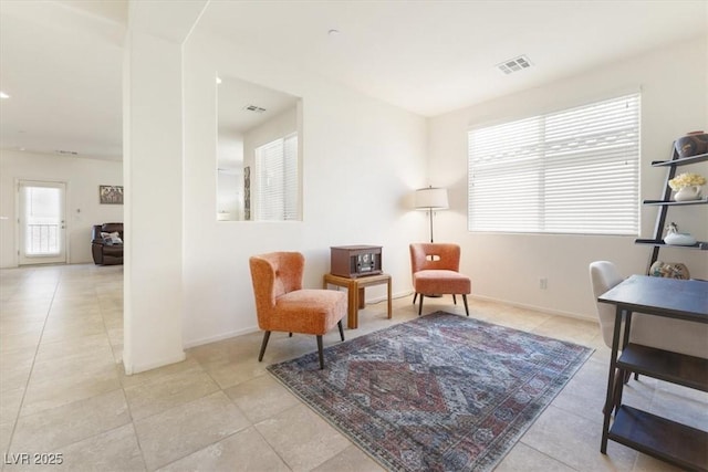 sitting room featuring light tile patterned flooring and visible vents