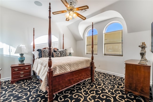 bedroom with lofted ceiling, ceiling fan, visible vents, and baseboards