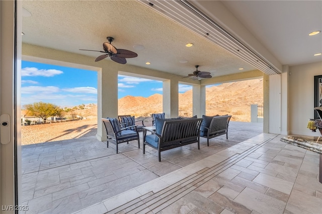 view of patio with a ceiling fan and outdoor lounge area