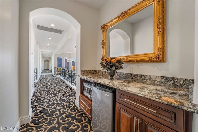 hall featuring recessed lighting, visible vents, and baseboards