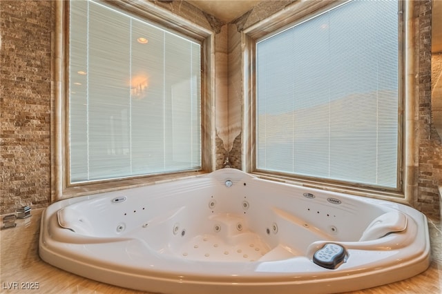 full bathroom featuring a tub with jets