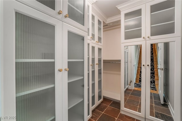 spacious closet with french doors and dark tile patterned floors