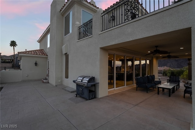 view of patio featuring ceiling fan, grilling area, and an outdoor hangout area