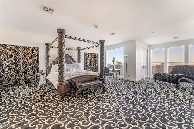 carpeted bedroom with access to exterior, visible vents, and baseboards