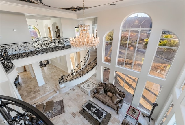 interior space with a chandelier, a towering ceiling, and a wealth of natural light