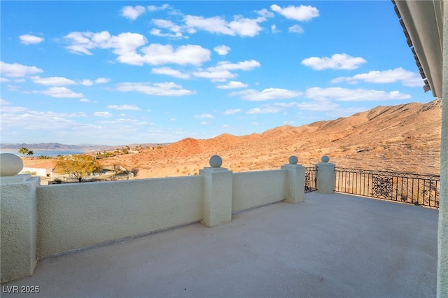 view of patio / terrace with a mountain view and a balcony