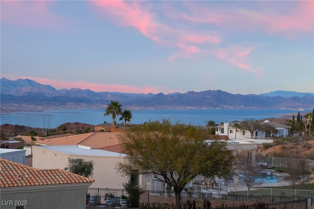 water view featuring fence and a mountain view