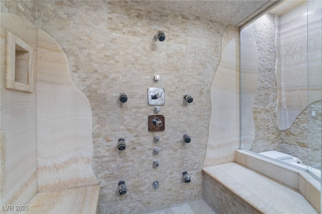 bathroom with tiled shower