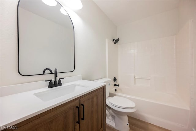 bathroom with toilet, tub / shower combination, wood finished floors, and vanity