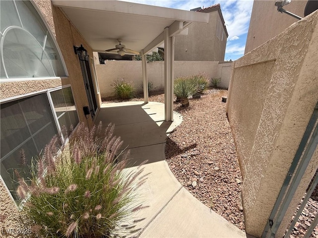 3331 Cheltenham St, Las Vegas, NV 89129 - fenced backyard with ceiling fan and a patio