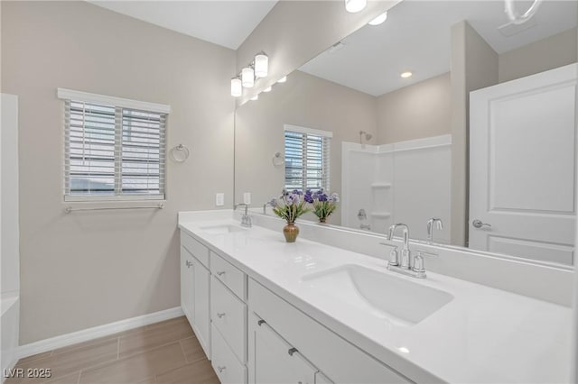 7177 W Camero Ave, Las Vegas, NV 89113 - full bathroom featuring double vanity, a sink, baseboards, and walk in shower